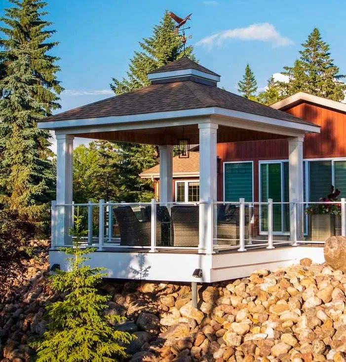 Covered deck with a gazebo roof, raised above a rock-landscaped slope